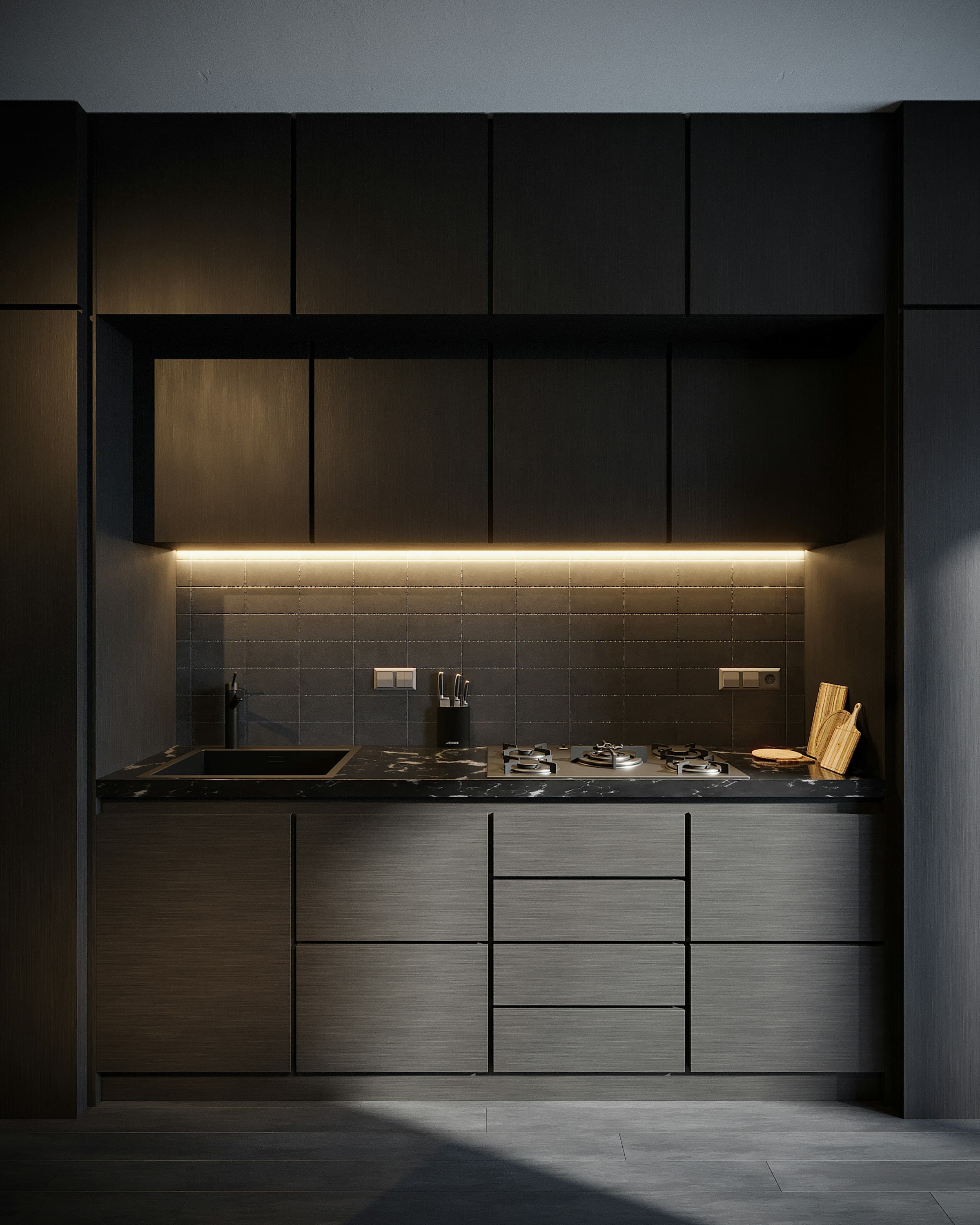 A dark, moody kitchen at dusk with warm under-cabinet lighting